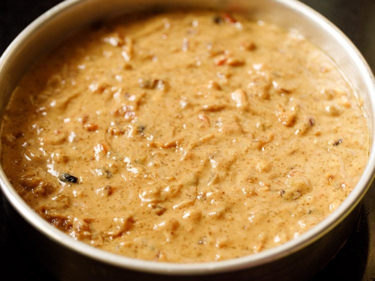 eggless fruit cake batter spread evenly in the cake pan