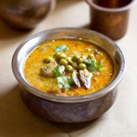 mushroom peas curry in a small metal pan