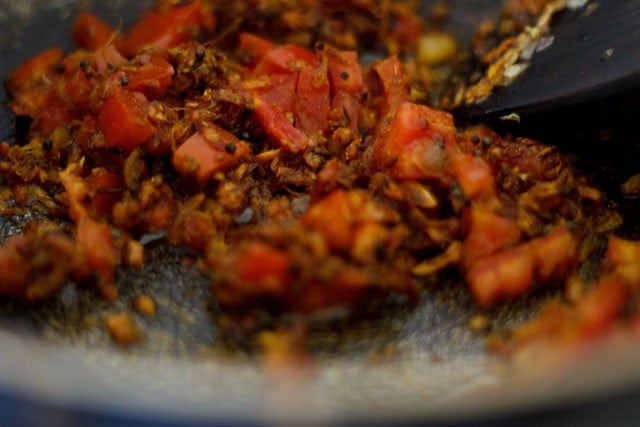 frying tomato masala till oil leaves the sides of the mixture 