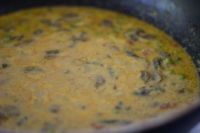 adding salt to curry and simmering 