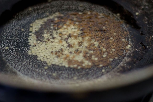 frying spices and urad dal in hot oil 