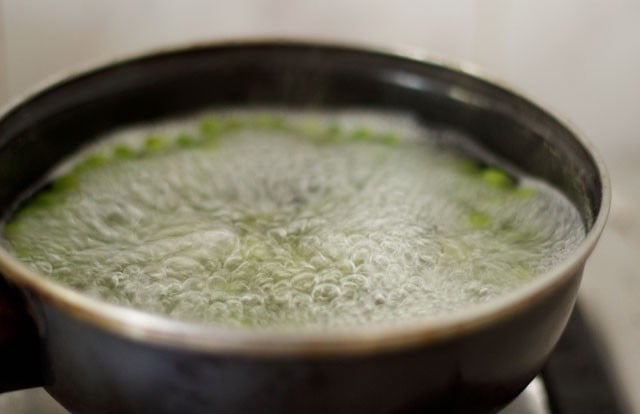 green peas getting cooked in water