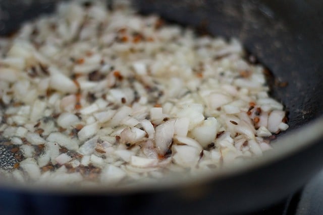 adding chopped onions to oil