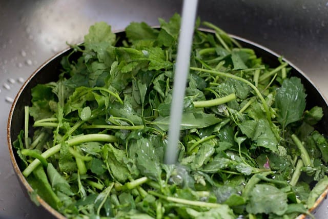 washing greens in batches.