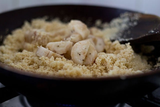 adding chopped bananas to semolina in pan.