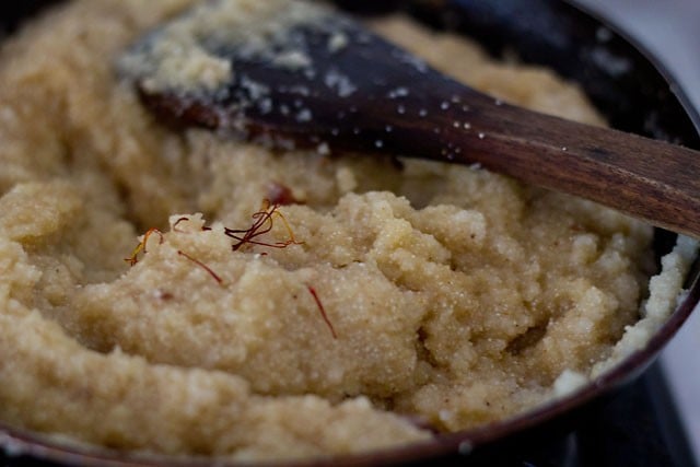 cooking banana halwa and adding crushed saffron at the last.