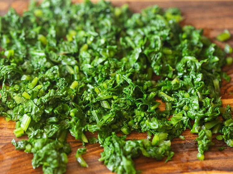 chopped spinach on a board