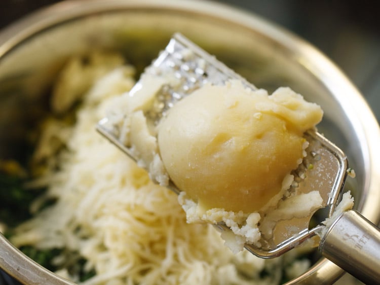 grated potatoes added to bowl