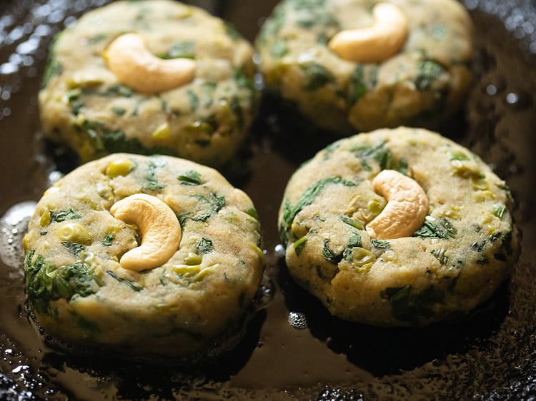 frying hara bhara kabab in a skillet