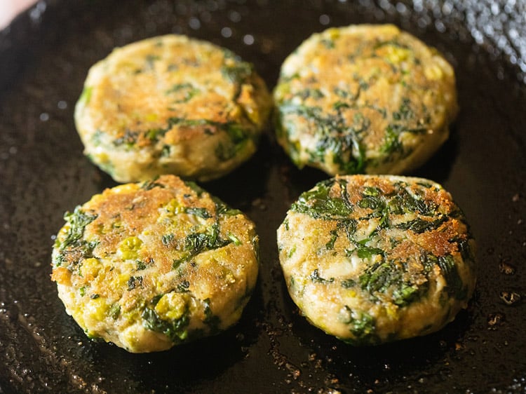 frying second side of hara bhara kabab in a skillet