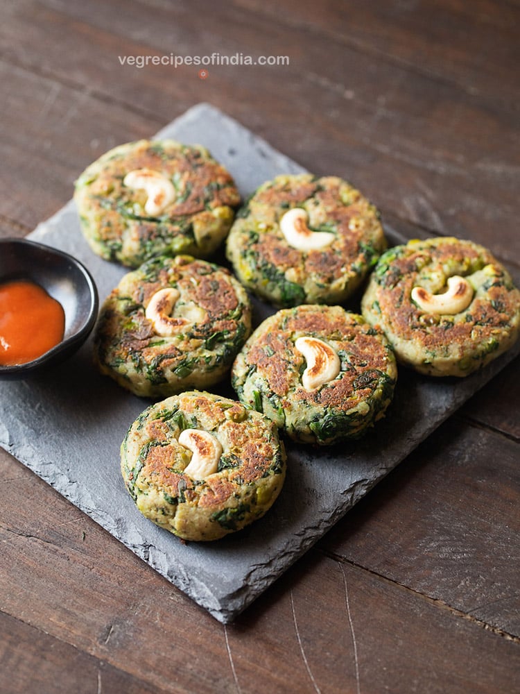 hara bhara kebab served on a board with sauce