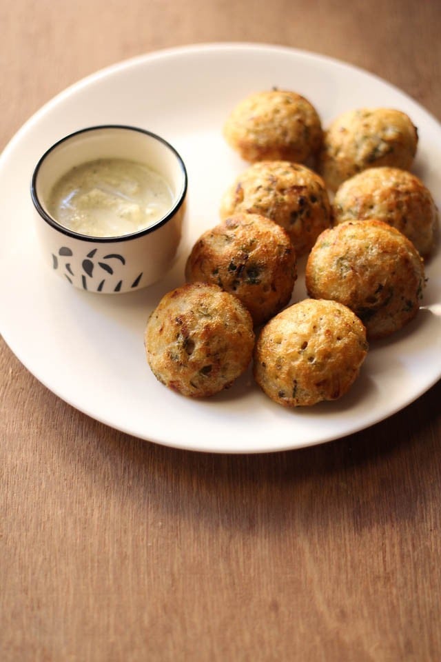 paniyaram recipe served in a white plate with coconut chutney in a bowl