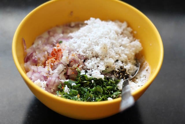 ingredients to make paniyaram batter in a bowl