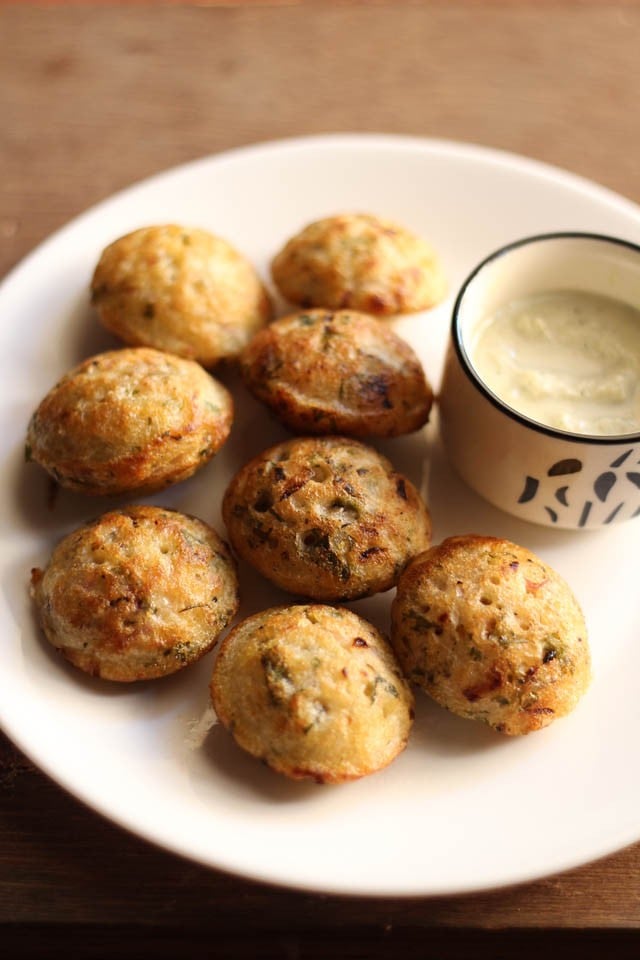 paniyaram recipe served in a white plate with coconut chutney in a bowl