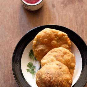 matar kachori served on a plate with chutney in a small bowl