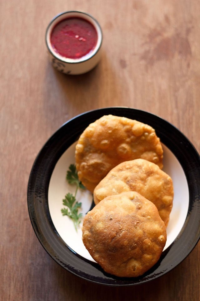 matar kachori served on a plate with chutney in a small bowl