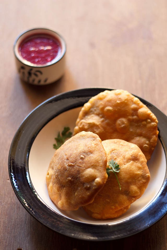matar kachori served on a plate with chutney in a small bowl