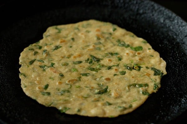 oil or ghee spread on the other side of the methi paratha