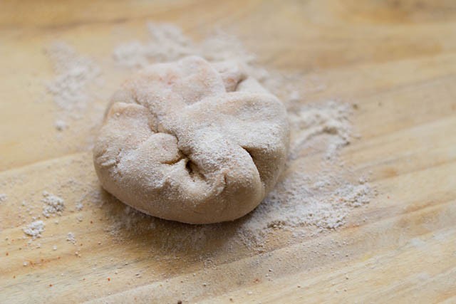 flattened stuffed paratha sprinkled with wheat flour 