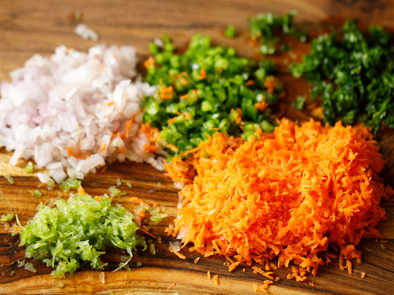 fresh veggies chopped on a wooden board for pasta salad