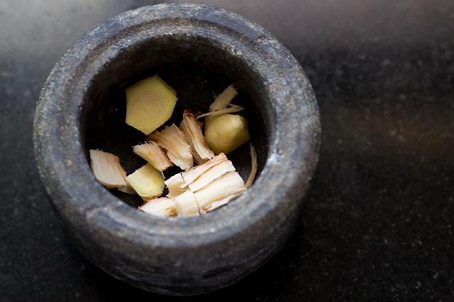 in a mortar & pestle take galangal and ginger