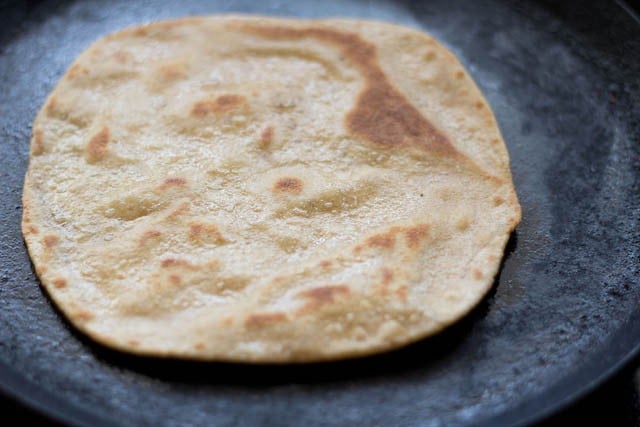 roasting ajwain paratha on hot tawa