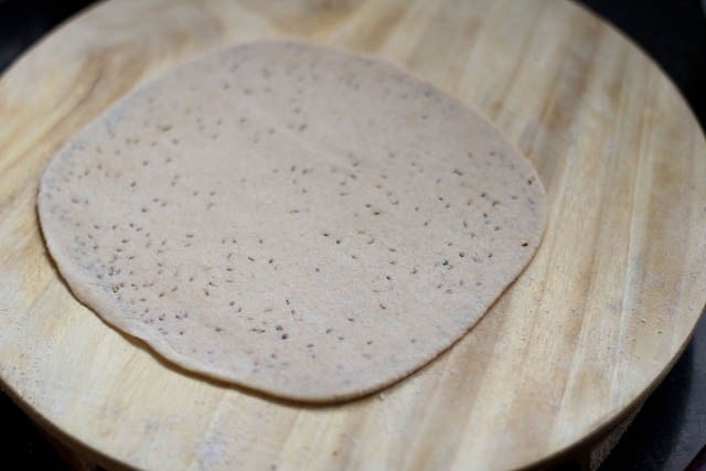 rolled ajwain paratha on a rolling board