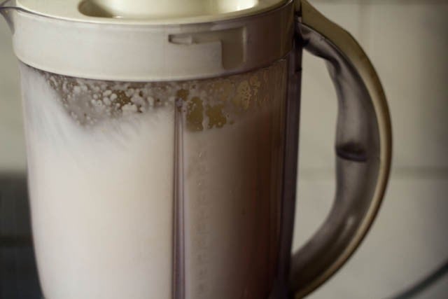 blending almonds with water to make almond milk.