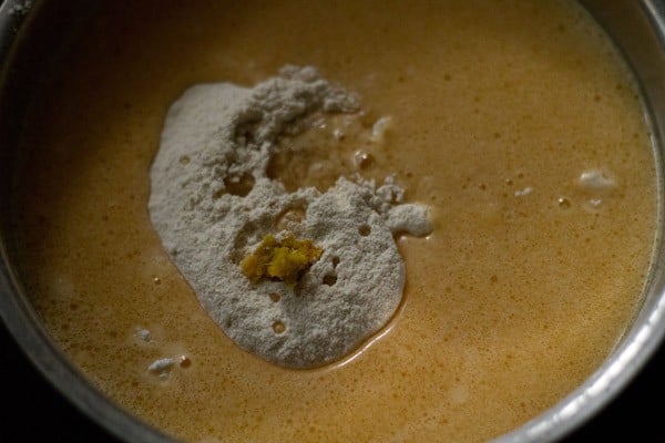 sieved flour, orange zest, orange extract in orange cake batter