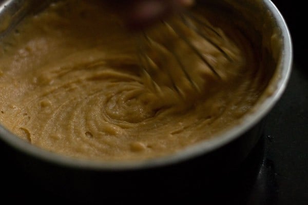 orange cake batter being mixed