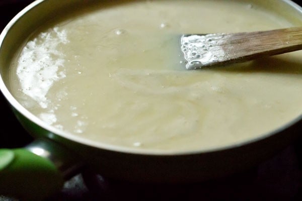 stirring custard that is visibly thick and creamy