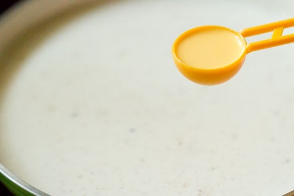 slurry being added to milk mixture by the tablespoon