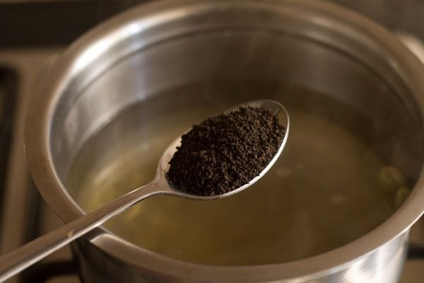 adding tea leaves in the pan