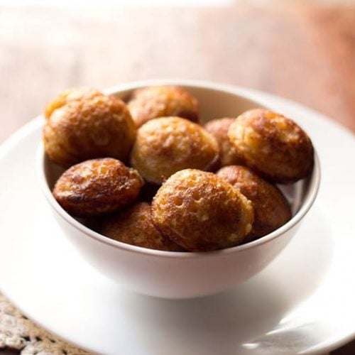 sweet paniyaram in a white bowl on a white plate