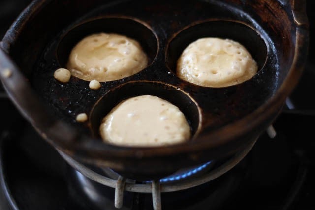 filling batter in paniyaram pan moulds 