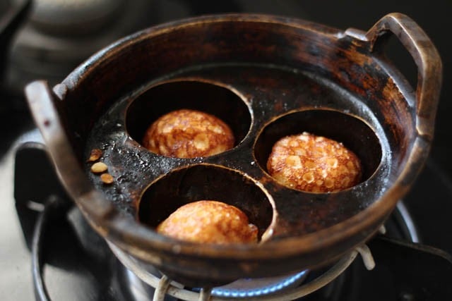 cooking sweet paniyaram in moulds 