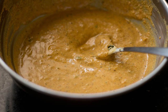 stirring the spiced curd-besan mixture