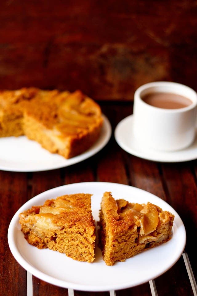 apple upside down cake served on a plate, with tea