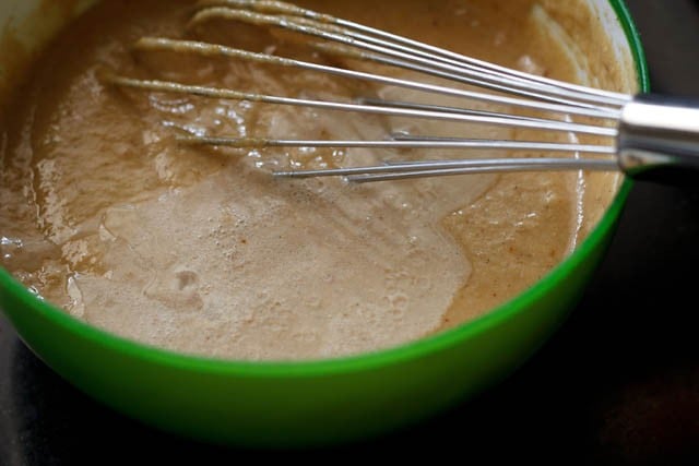 mixing lemon juice in cake batter in bowl