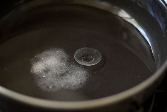 oil, water, and salt in a bowl for making my bajra roti recipe.