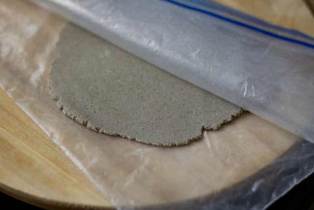 using a ziplock bag to roll out the bajra roti dough.