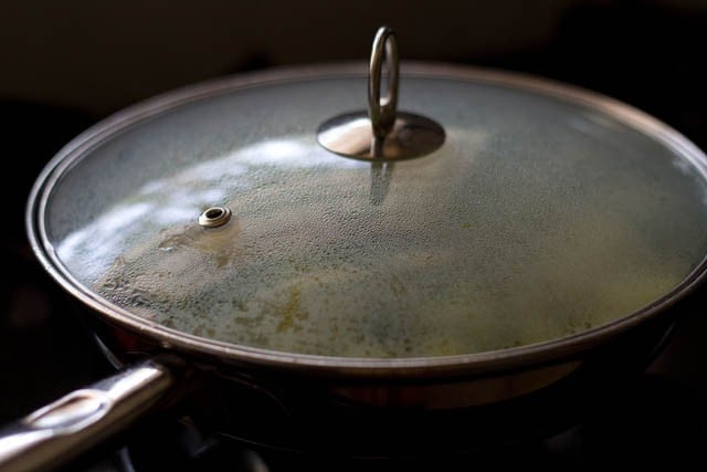 cooking bhaji with the lid on.