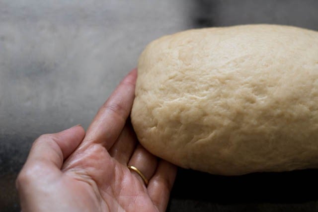 sealing edges on both sides of brown bread dough