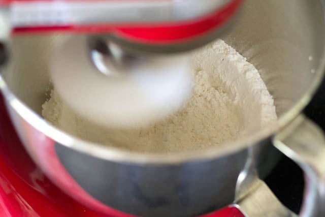 mixing salt, all-purpose flour and whole wheat flour in mixer