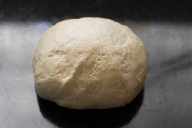 punching brown bread dough lightly