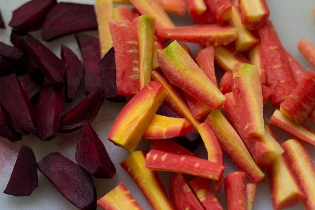 carrot and beets chopped on a white board