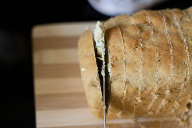 spread the garlic spread on the slices of the bread