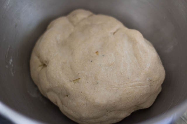 dough covered with a kitchen towl in a bowl