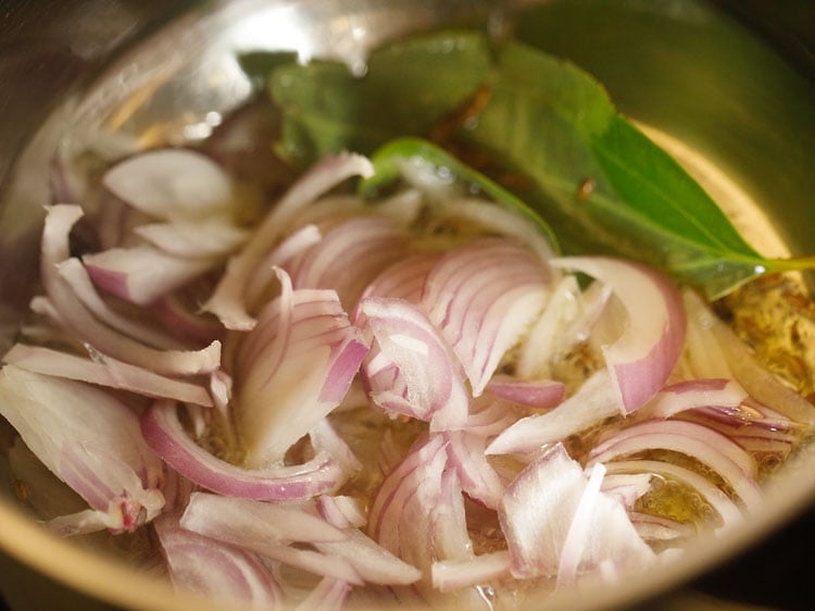 adding sliced onions in the pan