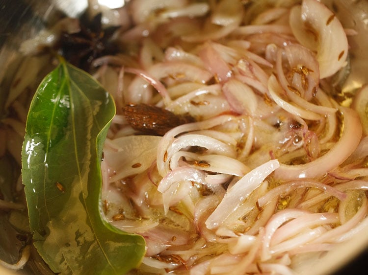 mixing onions with the ghee.